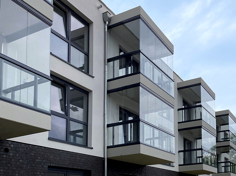 Mit ihrem eleganten rahmenlosen Design fügen sich die Verglasungselemente nahtlos in die moderne Fassadengestaltung ein. Foto: © Lumon