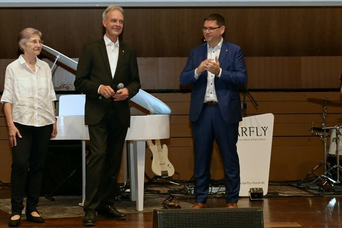 Hans Auracher (Mitte) hat seine Ämter beim ZVEH abgegeben. Auf der Jahrestagung wurde er verabschiedet. Mit ihm auf der Bühne: seine Frau Beate und ZVEH-Präsident Stefan Ehinger Foto: © ZVEH Hans Auracher (Mitte) hat seine Ämter beim ZVEH abgegeben. Auf der Jahrestagung wurde er verabschiedet. Mit ihm auf der Bühne: seine Frau Beate und ZVEH-Präsident Stefan Ehinger Foto: © ZVEH