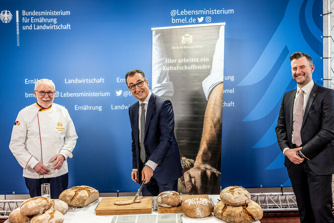 Bundesernährungsminister Cem Özdemir (M.) hat mit ZV-Präsident Michael Wippler (l.) und Hauptgeschäftsführer Daniel Schneider (r.) das Brot des Jahres 2022 offiziell vorgestellt, angeschnitten und natürlich auch probiert. Foto: © Zentralverband des Deutschen Bäckerhandwerks